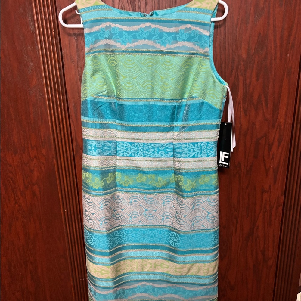 Brand new, figure-hugging dress with subtle shimmer